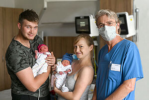 Mutter und Vater mit Neugeborenen Zwillingen. Mit auf dem Bild Oberarzt Uwe Graf.