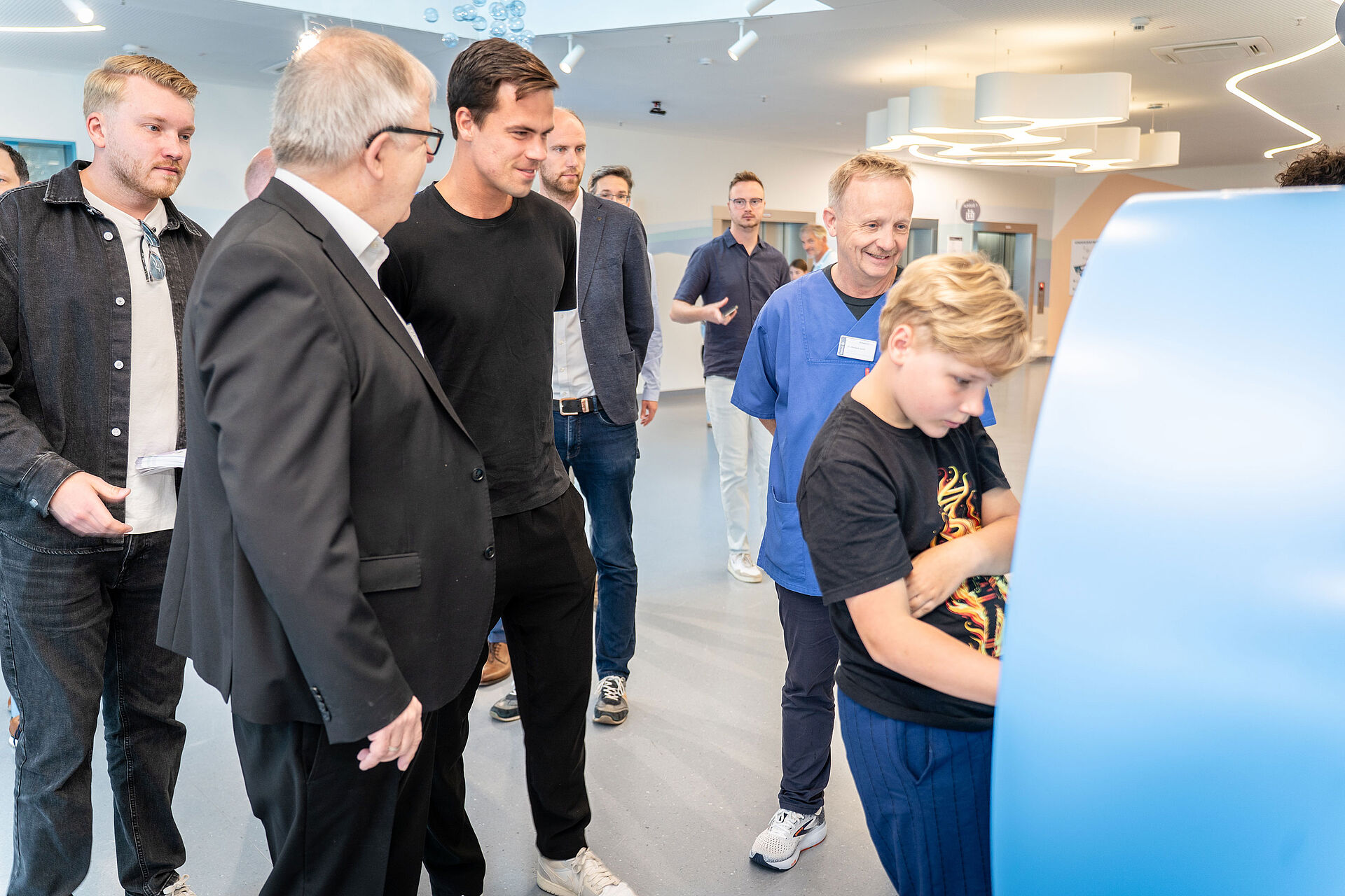 Terra Wortmann Open spenden 12.000 Euro: Tennisprofi Daniel Altmaier besucht das Betheler Kinderzentrum Patient Fabian Knuth zeigt Dennis Altmaier an einem Monitor, welche Kugel sein Bruder für das Kinderzentrum Bethel gestaltet hat.