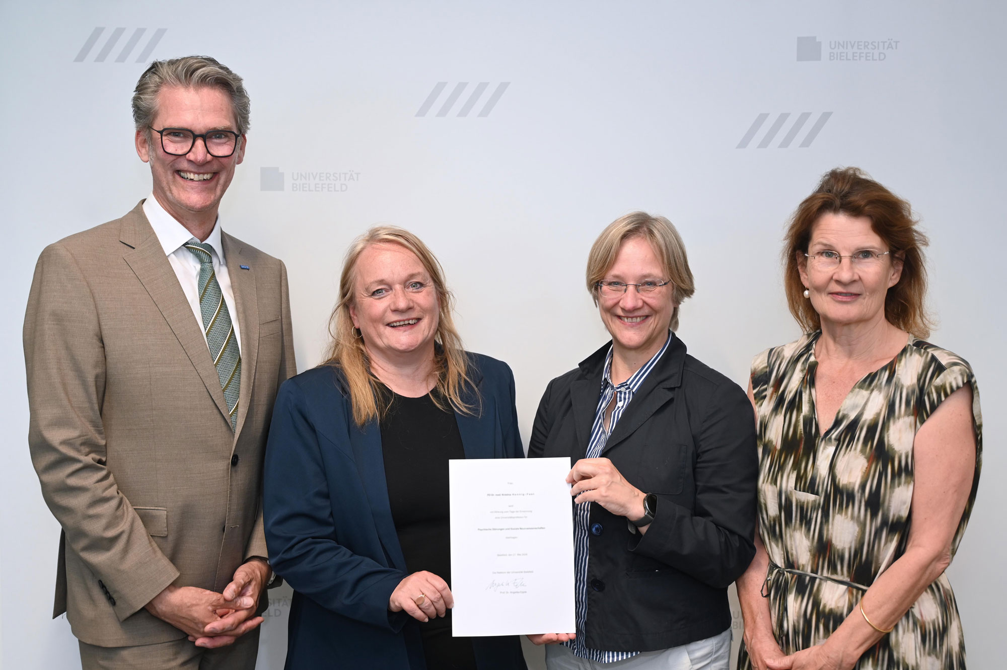Univ.-Prof.in Dr. Dr. Kristina Hennig-Fast (2.v.l.) erhält die Ernennungsurkunde von der Rektorin der Universität Bielefeld, Prof. Dr. Angelika Epple. Links: EvKB-Geschäftsführer Thorsten Kaatze, rechts: Prof. Dr. Claudia Hornberg, Dekanin der Medizinischen Fakultät OWL. Foto: Manuel Bünemann